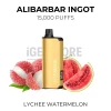 Alibarbar Ingot Lychee Watermelon 15000 Puffs gold pod kit beside peeled lychees and watermelon slices