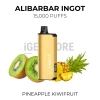 Alibarbar Ingot Pineapple Kiwifruit 15000 Puffs gold pod kit beside halved kiwifruit and fresh pineapple
